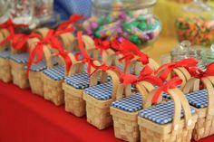 several baskets with red bows are lined up on a table