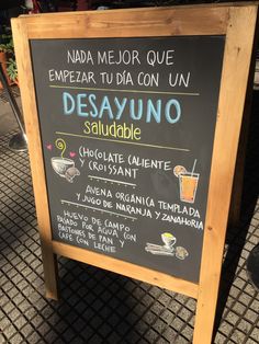 a sign that is on the side of a sidewalk with words written in spanish and english