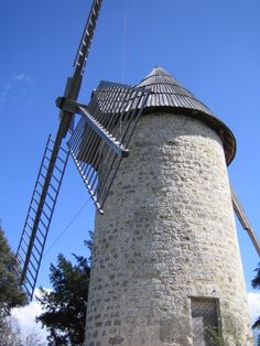 an old stone windmill with a ladder going up it