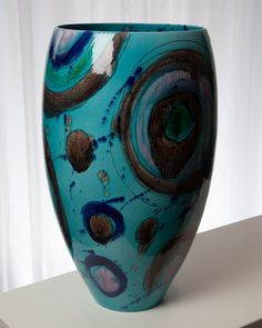 a blue vase sitting on top of a table