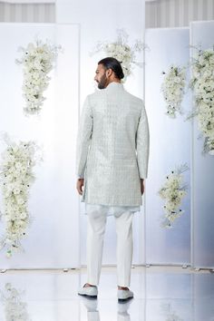 This sherwani set features all over gota embroidery on a powder blue raw silk base. It is paired with a matching silk kurta and an off-white cotton trouser. Completing footwear is also available.From Seema Gujral's Tuscan Summer collection. DELIVERY TIMEPlease allow 4 months for your outfit to arrive.FABRIC DETAILSRaw SilkProfessional cleaning only. Wedding Nehru Jacket With Mirror Work, Festive Sherwani With Gota Work For Eid, Eid Festive Sherwani With Gota Work, Designer Gota Work Kurta For Diwali, Blue Bollywood Sherwani With Gota Work, Blue Sherwani With Gota Work, Designer Blue Sherwani With Gota Work, Designer Festive Nehru Jacket With Gota Work, Festive Bandhgala With Gota Work For Reception