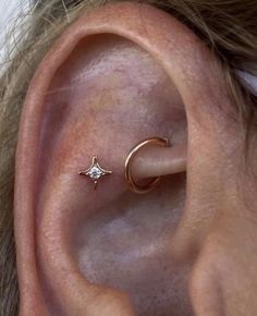 an ear with a small star and moon on it