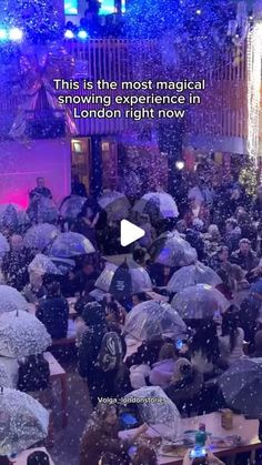 a crowd of people holding umbrellas in the rain with text overlay that reads, this is the most magical snowing experience in london right now