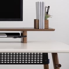 a computer desk with a monitor and keyboard on it