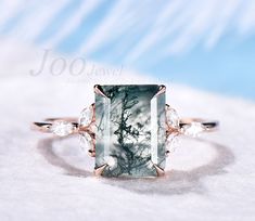 Main Ring: 7x9mm emerald cut moss agate. Marquise 1.5x3mm moissanites. The band width is about 1.5mm. Material Metal: 925 sterling silver, Solid 14k/18k gold,platinum PLEASE choose silver or platinum if you are allergic to nickel. This jewelry is made to order, it can be made with any gemstone/metals. 2-3 weeks to finish. Default Shipping method is usps. 30 days non-hassle return policy.For returned items,there may be handcrafting and shipping fee deducted. Agate Wedding Ring, Art Deco Flower, Rose Gold Moissanite Ring, Moss Agate Engagement Ring, Engagement Ring Art Deco, Green Moss Agate, Opal Wedding Rings, Agate Engagement Ring, Moss Agate Ring