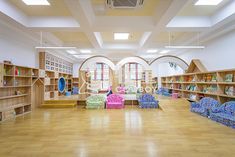 an empty library with chairs and bookshelves filled with children's toys in it