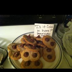 some cookies are on a plate with a sign that says it's cold in here