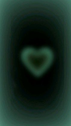 a heart shaped object in the middle of a black and green background