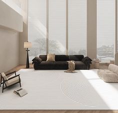 a living room filled with furniture and large windows covered in blind shades on top of them