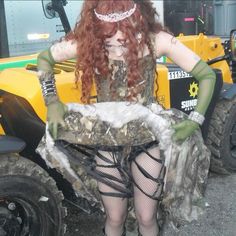 a woman with red hair sitting on top of a vehicle