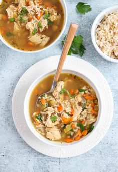 two bowls filled with chicken and rice soup