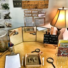 an office cubicle with several items on the desk and in front of it is a lamp