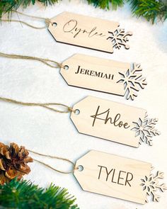 three wooden tags hanging from a christmas tree