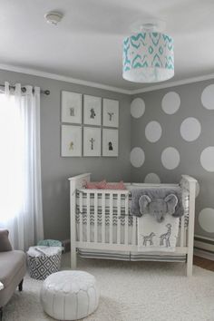 a baby's room with gray and white decor