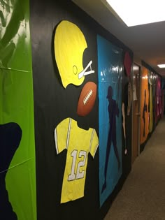 an office hallway decorated with football uniforms and paper cutouts on the wall for decoration