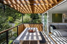 a wooden table sitting on top of a patio