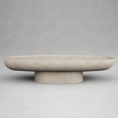 an oval stone table on a grey background