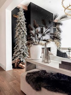 a living room filled with furniture and christmas trees