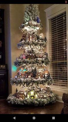 a christmas tree is decorated with lights and snow