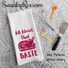 a towel with the words all about that baste on it next to utensils