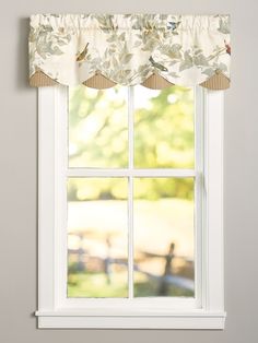 a window with a bird and flower valance