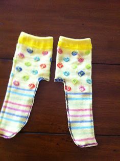 two pairs of baby leggings on a wooden floor