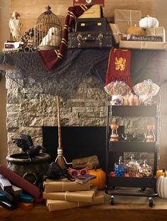 a fireplace with books, candles and other items on it