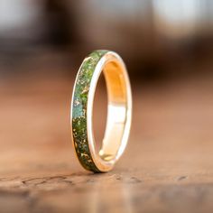 Presenting The Erinn - a beautiful gold women's wedding band made of 100% recycled gold and a captivating center inlay of green imperial diopside and gold flakes. Inspired by the emerald landscapes of Ireland, this ring is perfect for the bride who wants a piece of jewelry that is both timeless and unique.The Erinn Ring Features: SCS certified 100% recycled gold ring base Available in: 10K, 14K or 18K yellow gold, rose gold or white gold Natural imperial diopside ring inlay with gold flakes Hand Recycled Gold Ring, 10k Gold Ring, Gold Mining, Gold Flakes, Womens Wedding Bands, 14k Gold Ring, Recycled Gold, Gold Wedding Band, Engraved Rings