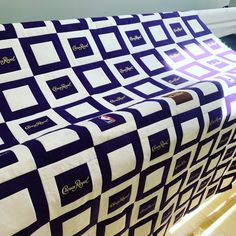 a blue and white quilt sitting on top of a wooden floor