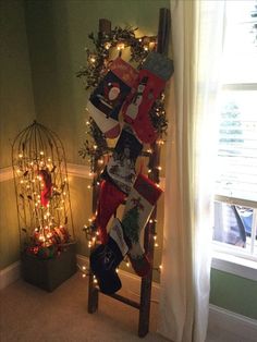 a ladder decorated with stockings and christmas lights