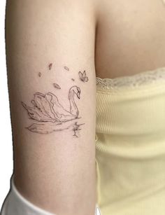 a woman with a swan tattoo on her arm