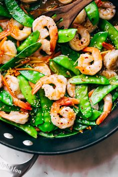 stir fry with shrimp and snow peas in a wok