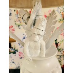 there is a white figurine that has wings on it