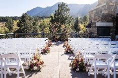 an outdoor ceremony set up with white chairs