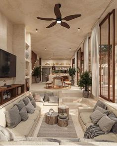 a living room filled with lots of furniture and a flat screen tv mounted on the wall