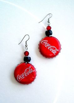 coca - cola bottle cap earrings with swaroons dangling from the earwires