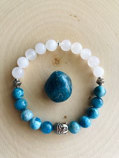 Beautiful genuine grade AAA Ocean Blue Apatite and Clear Quartz 8mm beaded gemstone bracelet, uniquely adorned with a silver Buddha charm and small silver accents.  Made with 1mm elastic cord, this bracelet measures 7.5 - 8 inches and can stretch to fit most wrists.  Handmade with love and healing energy in Franklin, Tennessee!  Connect with me on Instagram! @cosmicmoonfairyjewelry Gemstone Bracelet Ideas, Hope Diamond, Love And Healing, Franklin Tennessee, Healing Gemstone Bracelets, Beads Design, Diy Bracelet Designs, Beads Bracelet Design, Handmade Jewelry Tutorials