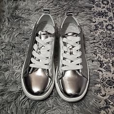 Brand New Silver Tennis Shoes Size 7.5, Never Worn, 9.75" Front To Back, Padded Insole Sf/Pf Trendy Metallic Lace-up Sneakers, Metallic Lace-up Sneakers, Metallic Round Toe Casual Sneakers, Silver Synthetic Round Toe Sneakers, Casual Metallic Sneakers With Round Toe, Metallic Sneakers With Perforated Toe Box, Metallic Low-top Sneakers For Spring, Spring Metallic Low-top Sneakers, Metallic Sneakers With Round Toe For Spring