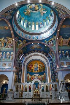 the inside of a church with many paintings on it