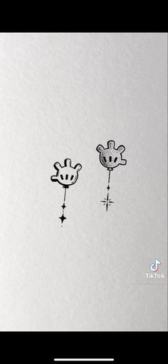 two giraffes are drawn on the side of a white paper with black ink