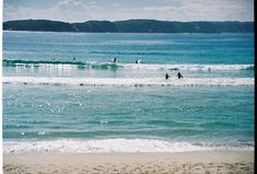 some people are out in the water on their surfboards