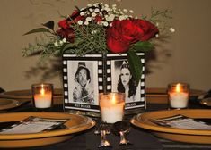 the table is set with candles and pictures on it, along with roses in vases