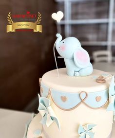 a cake with an elephant sitting on top of it's icing and decorations