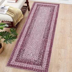 a living room with wooden floors and a rug on the floor