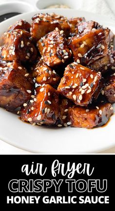 an air fryer honey garlic tofu recipe on a white plate with sesame seeds