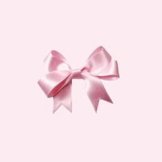 a pink bow is shown against a light pink background