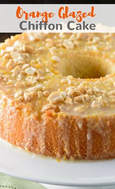 a bundt cake on a white plate topped with nuts