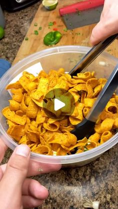 a person cutting up some food in a bowl