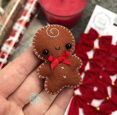 a hand holding a small felt ginger ornament