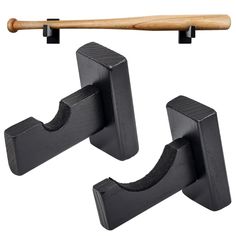 two pieces of black wood hang on hooks